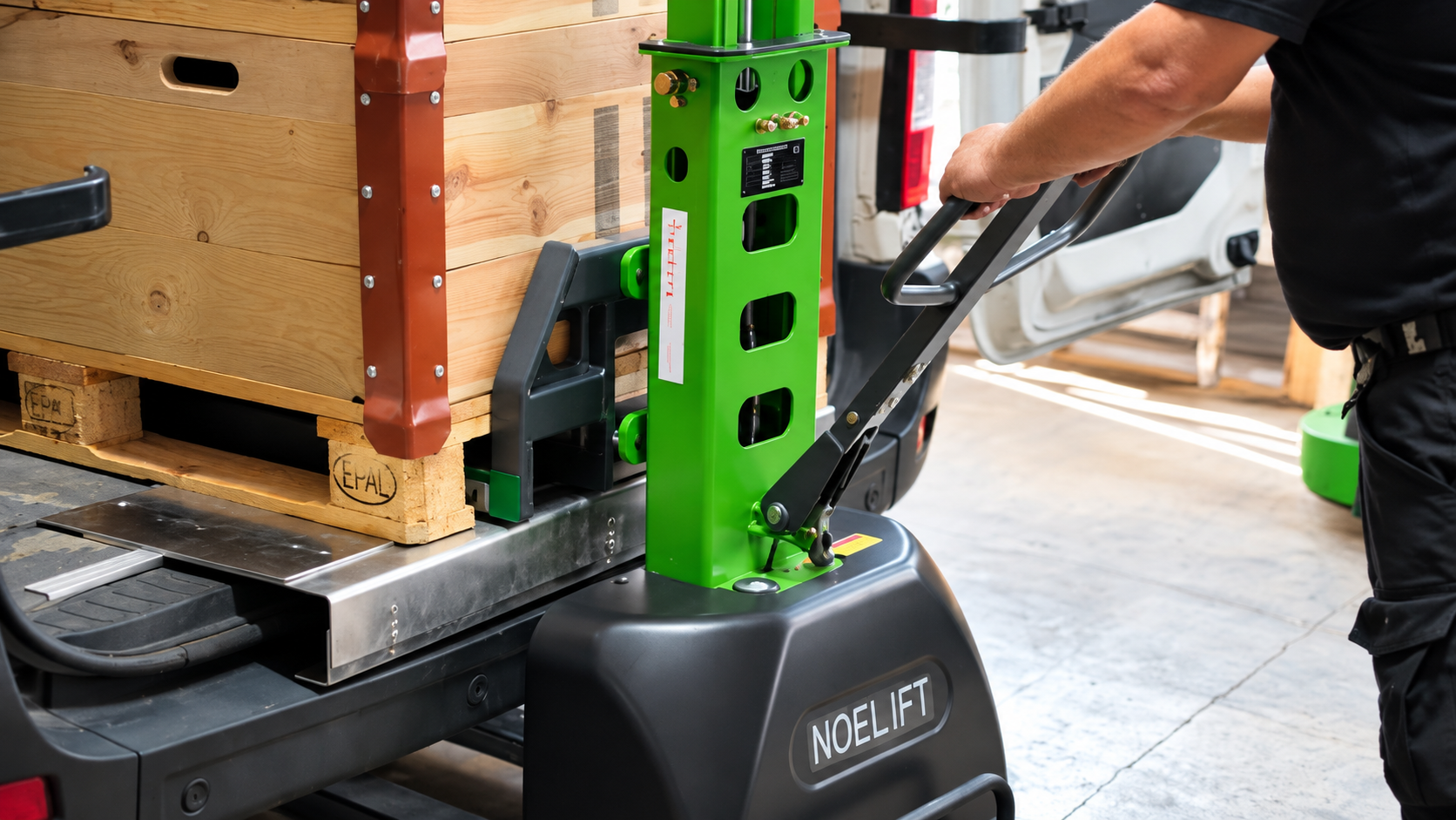 NOELIFT demonstration reference showing a palletized wooden crate at a cargo van’s loading floor